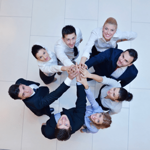 Business people joining hands as a team in a circle