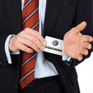 Businessman pulling a coaching card out of his sleeve