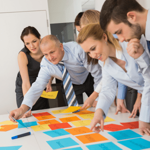 Business team brainstorming using coloured labels on an office table