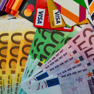 A colourful selection of different denominations of Euro notes and two Visa credit cards