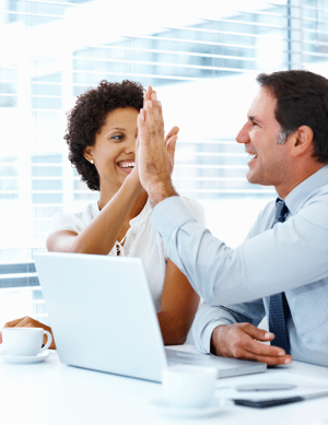 Business people high-fiving in the office