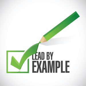 Green lead by example check mark and pencil