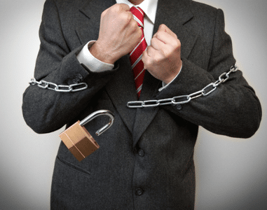 Businessman breaking a padlock and chain