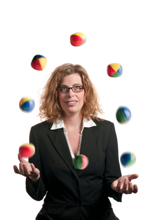 A businesswoman juggling many balls all at once
