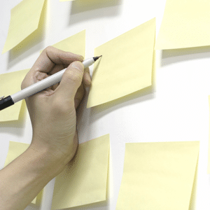 Hand writing on yellow post-it notes