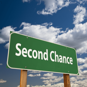 A green road sign reading: Second Chance