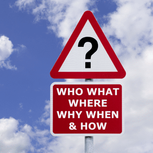 Signpost with the six most commonly asked questions against a cloudy sky