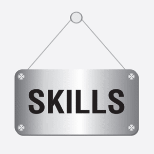 Silver metallic skills sign hanging on a wall
