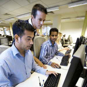 A team of people working together in a computer lab