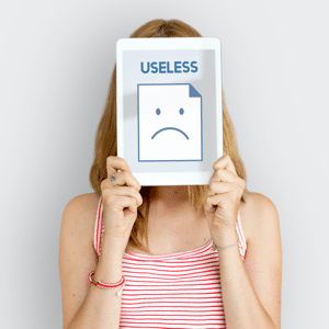 Woman holding up a card with the word useless