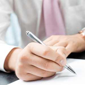 Closeup of businessman writing a document in the office