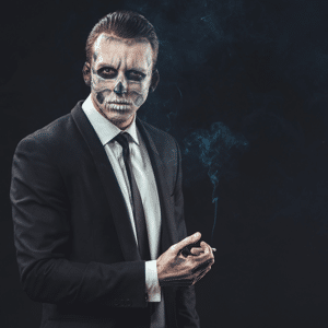 Businessman smoking with make-up skeleton